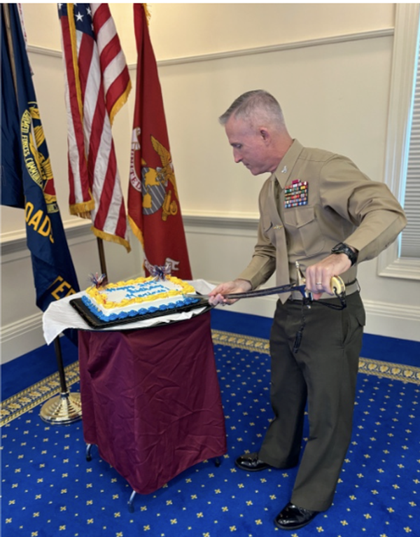 In November, Col. Edward Healey of ESG-2 cuts the USMC birthday cake with a Marine officer sword.